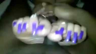 Indian woman with long toenails giving footjob