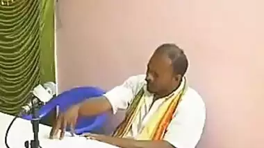 Hindu couple worshipping Shiva Lingam inside Temple 