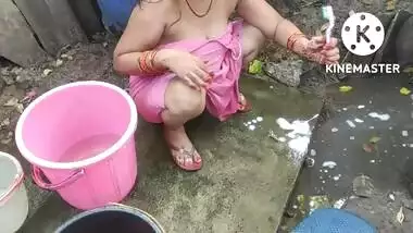 Indian house wife bathing outside