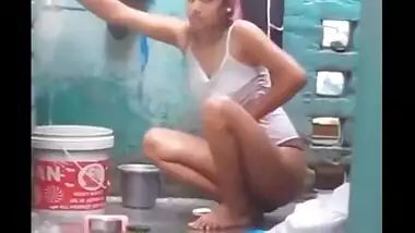 Young village girl taking a bath