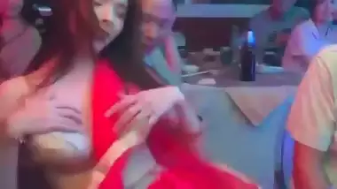 An old man squeezes a whore’s boobs at a public gathering