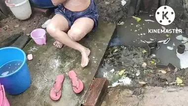 Indian house wife bathing outside