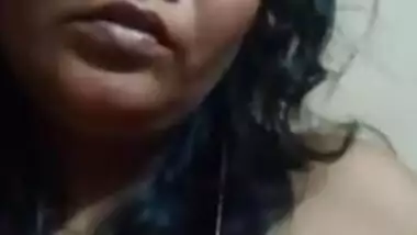 Desi mom with serious face sits before camera topless in solo sex clip