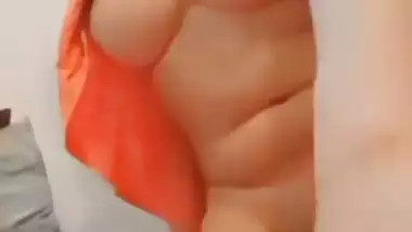 The naked girl fingers her wet pussy during a video call sex