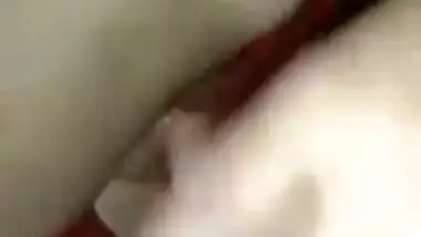 Wife lies on the bed letting the Desi hubby film the porn video