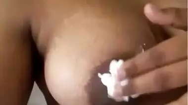 sexy desi girl applying cream in boobs