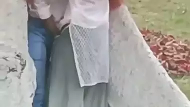 College couple enjoys outdoor sex below a big tree